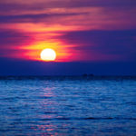 Red Purple sunset into the blue ocean with two ships in the horizont, Koh Rong Sanloem, Cambodia, Asia