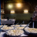 Tripoli Lebanon Cheese maker with large pans in a dark room in the souks