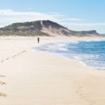 Footsteps of a female runner at the white sanded beach of Peterborough at the Great Ocean Road, Victoria, Australia