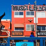 Man training figures in front of muscle beach building, Venice Beach, Los Angeles, California